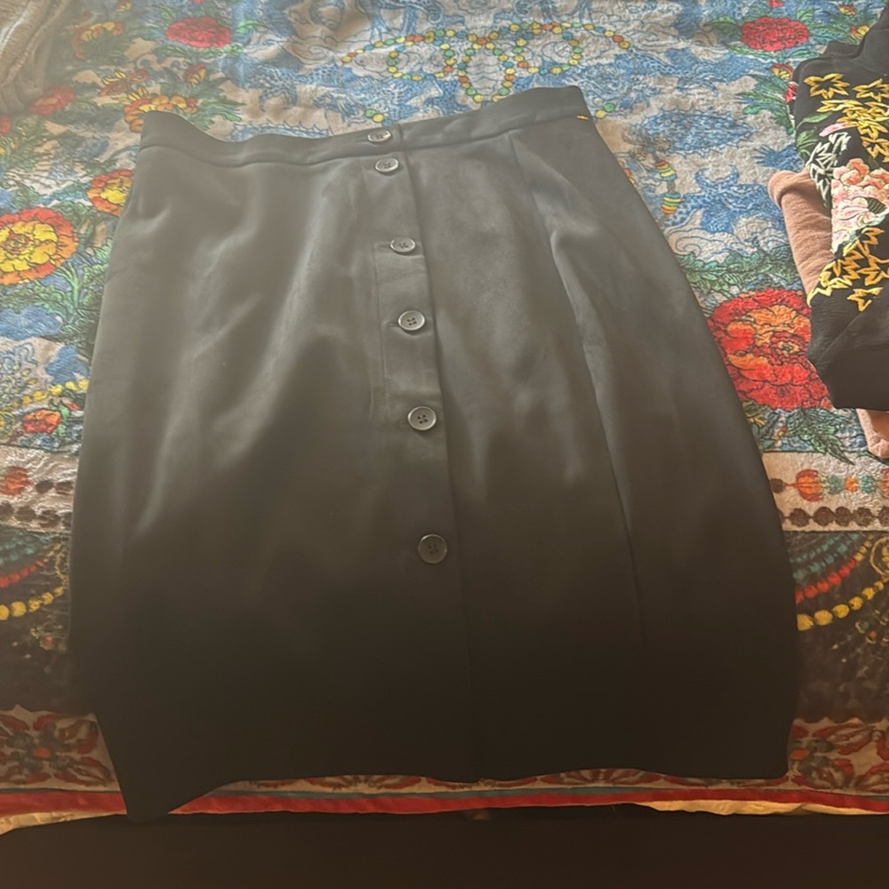 A pencil skirt very cute corduroy with six buttons going down